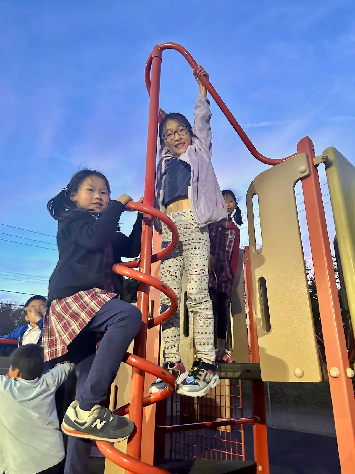 Morningstar students climbing and playing on the playground